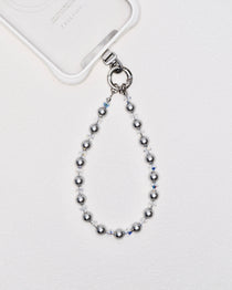 Detail view showing Gray Swarovski pearl phone chain with white crystal accents and silver-tone phone hardware.