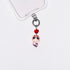 Product photo showing Pink character-inspired phone charm with a red crystal heart and silver-tone phone hardware.