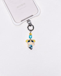 Product photo showing Blue character-inspired phone charm with colorful crystal accents and silver-tone phone hardware.