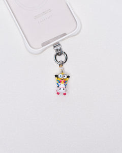 Product photo showing Vintage yellow unicorn-inspired phone charm with pink and blue crystal accents and silver-tone phone hardware.