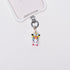 Product photo showing Vintage yellow unicorn-inspired phone charm with pink and blue crystal accents and silver-tone phone hardware.