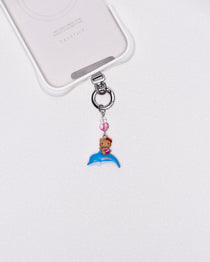 Product photo showing Vintage dolphin character-inspired phone charm with a blue crystal heart and silver-tone phone hardware.