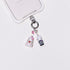 Product photo showing Vintage character-inspired phone charm with pink and gray figures, crystal accents, and silver-tone phone hardware.
