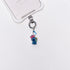 Product photo showing Vintage blue character phone charm with colorful crystal accents and silver-tone phone hardware.