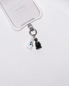 Product photo showing Vintage dragon-inspired phone charm with a black-and-white figure, crystal accent, and silver-tone phone hardware.