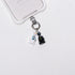 Product photo showing Vintage dragon-inspired phone charm with a black-and-white figure, crystal accent, and silver-tone phone hardware.