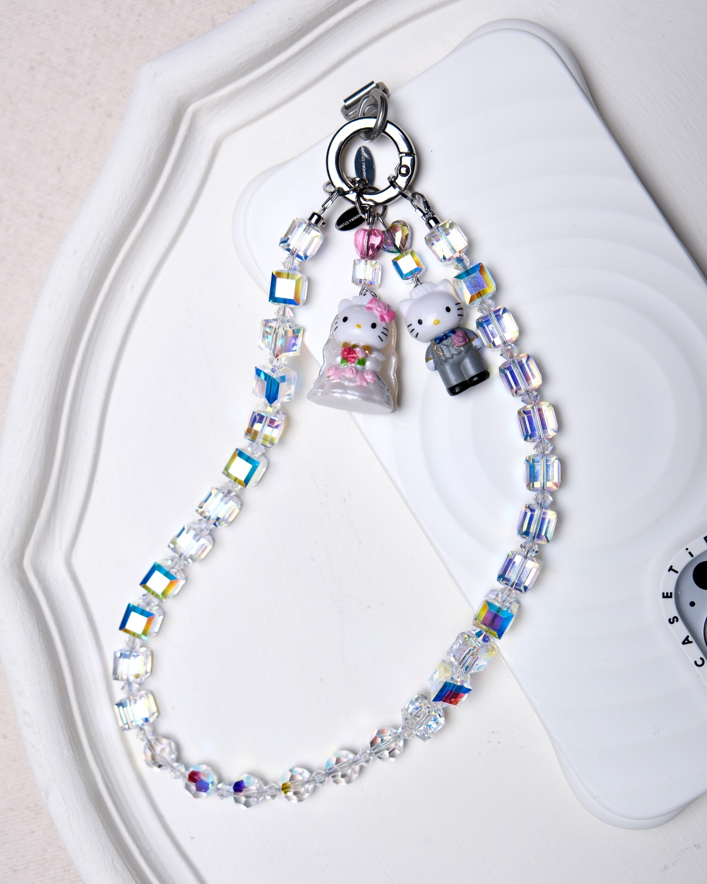 Aurora Borealis Swarovski crystal phone chain styled with detachable vintage charms and silver-tone phone tab