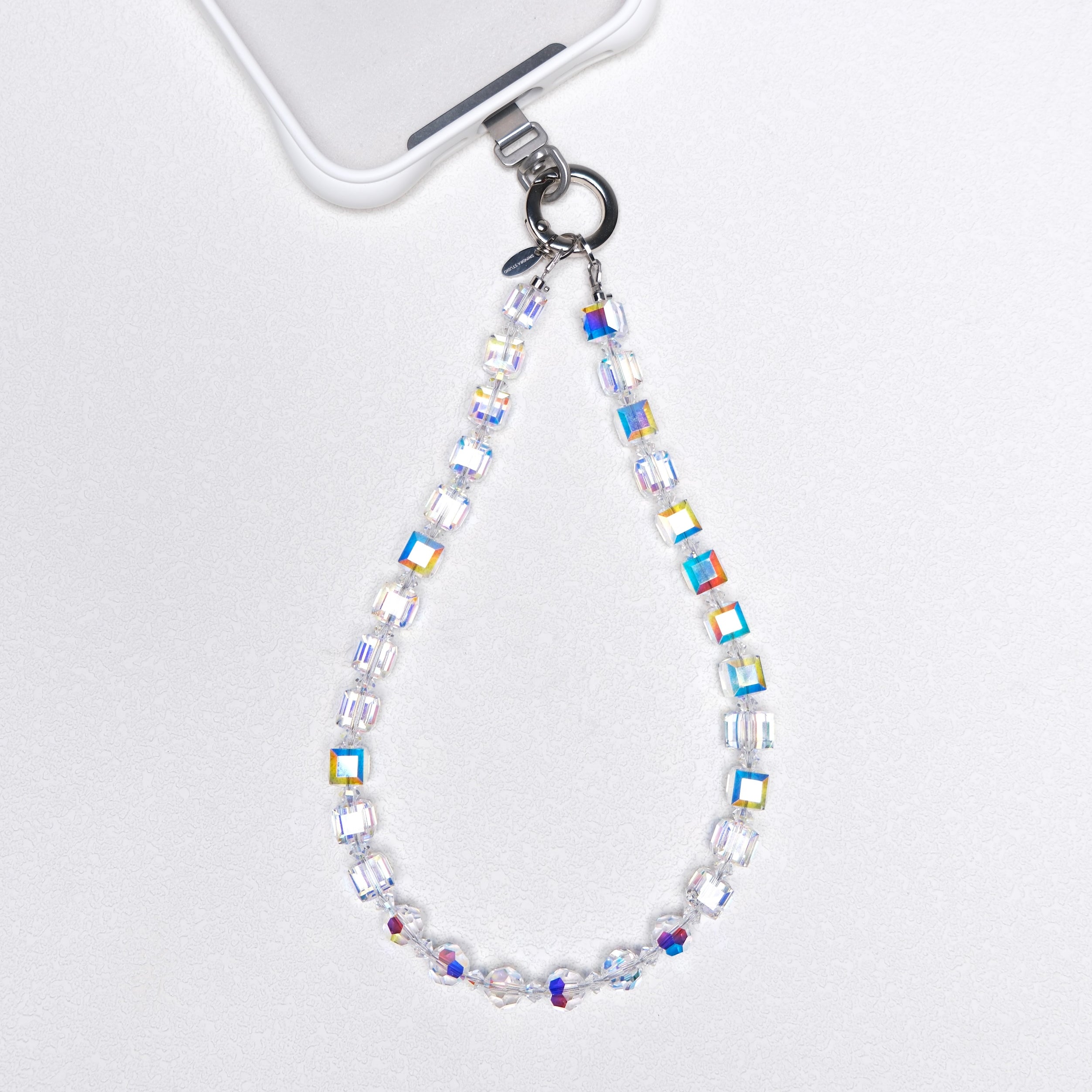 Aurora Borealis Swarovski crystal phone chain attached to a white phone case