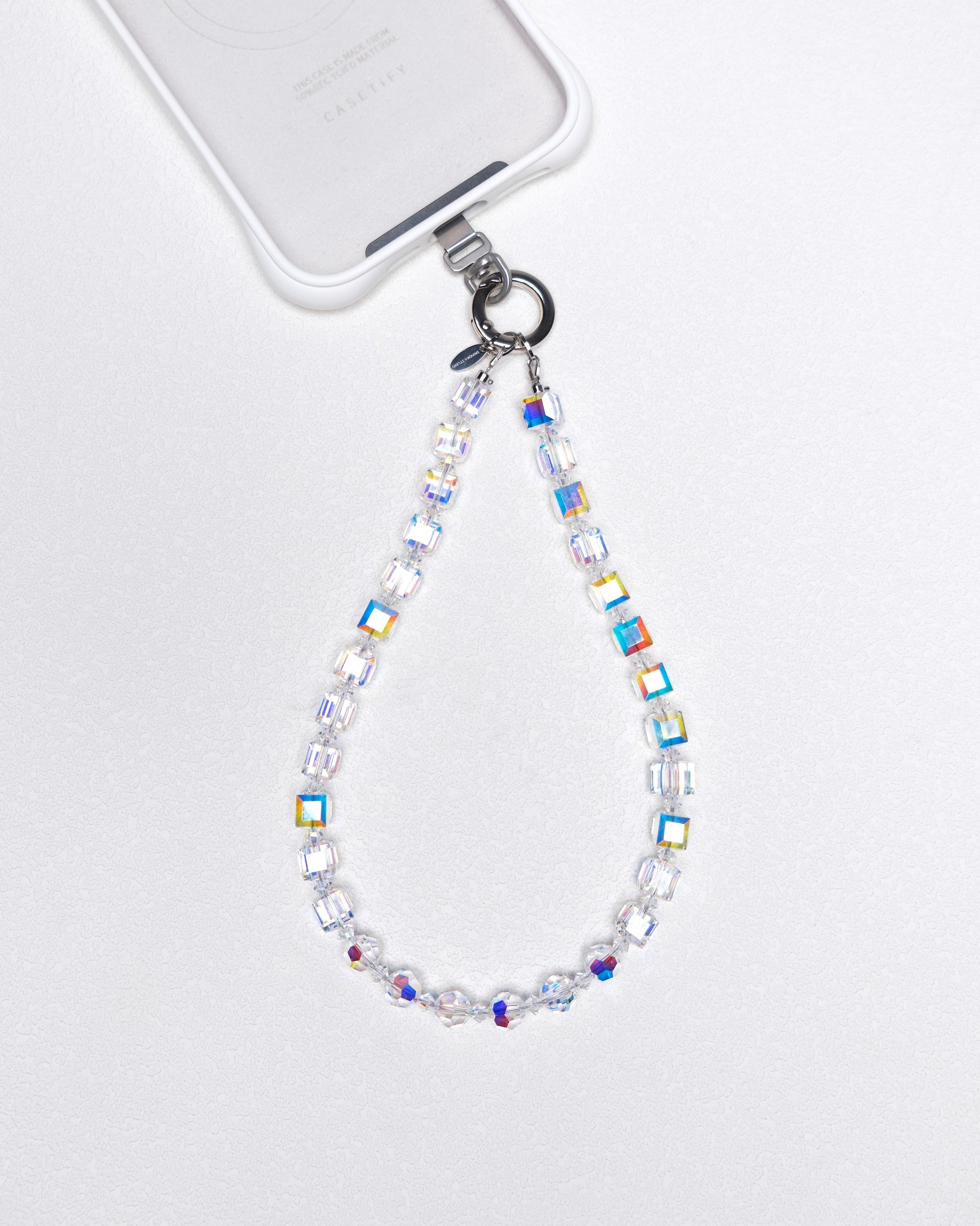 Aurora Borealis Swarovski crystal phone chain attached to a white phone case