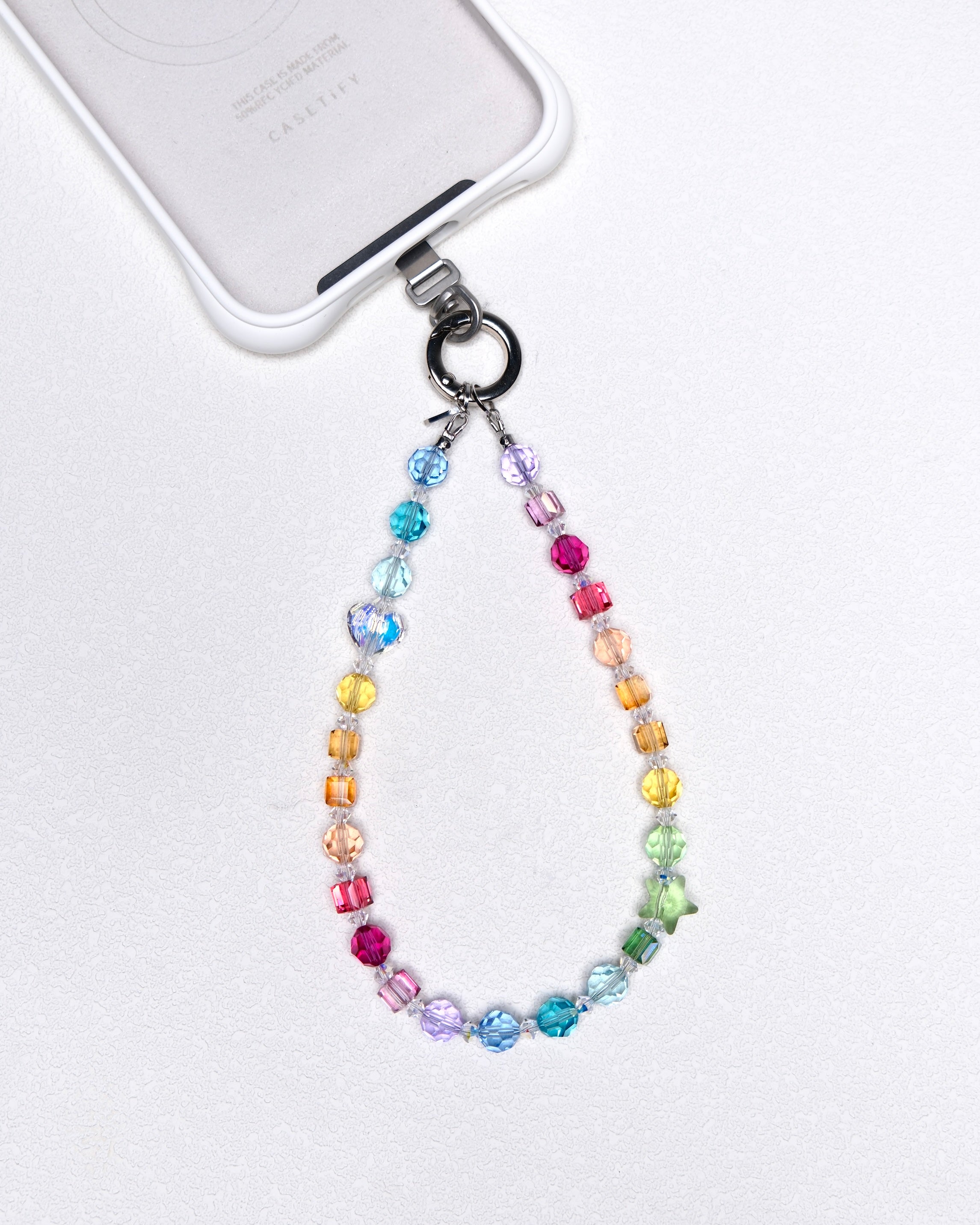 Product photo of a rainbow Swarovski crystal phone chain with multicolor crystal details.