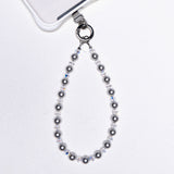 Product photo of a gray Swarovski pearl phone chain with white crystal accents.
