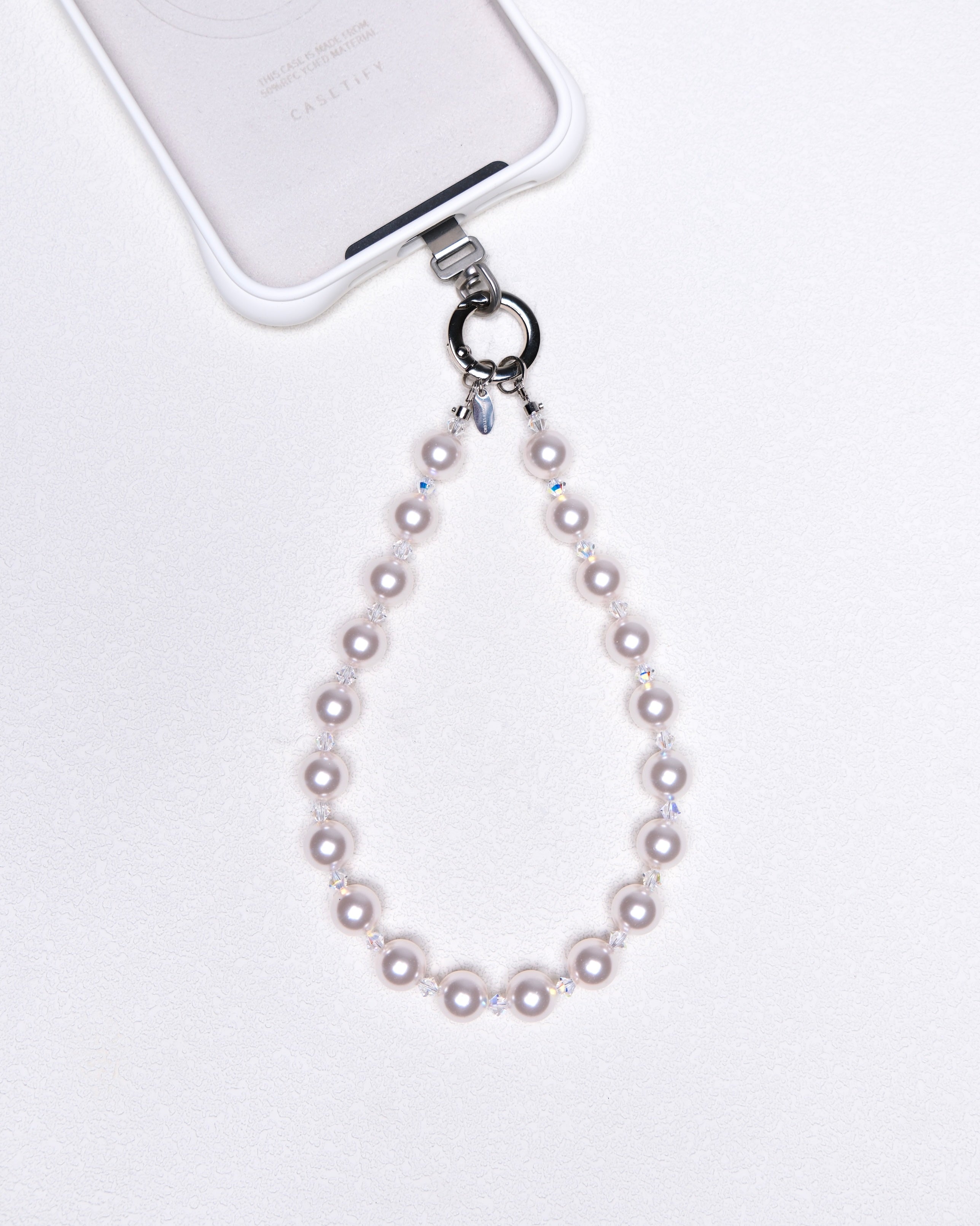 Product photo of a Swarovski pearl and crystal phone chain with silver-tone phone hardware.
