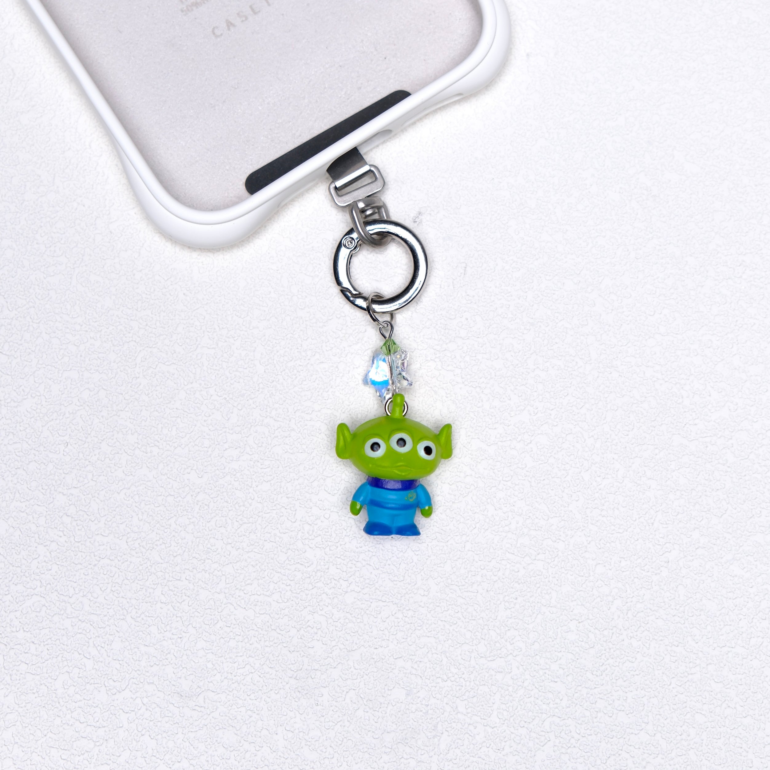 Green three-eye vintage phone charm with green Swarovski crystal accents and silver-tone hardware