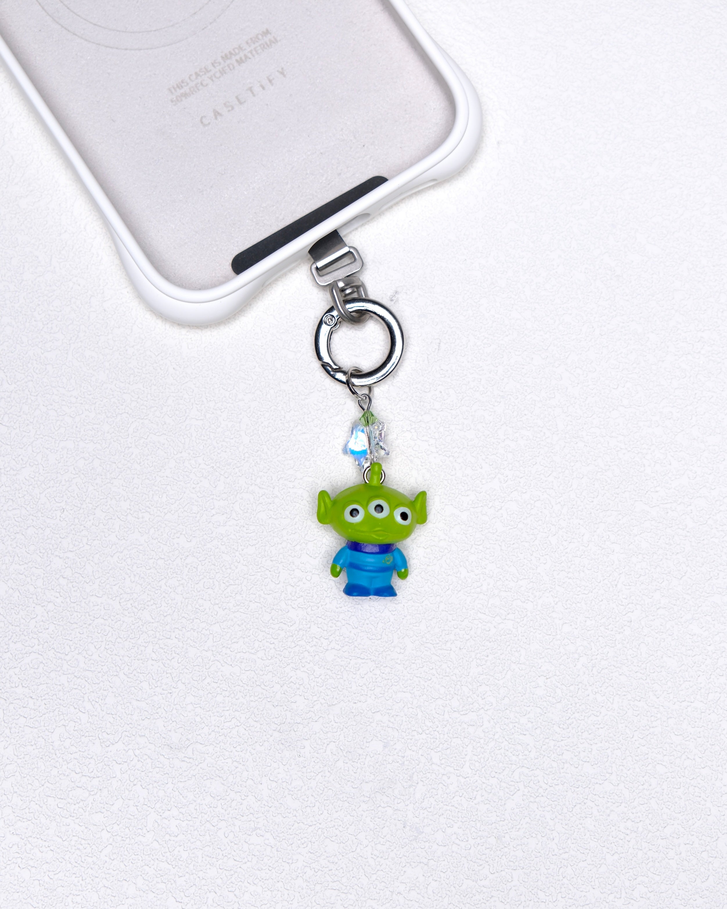 Green three-eye vintage phone charm with green Swarovski crystal accents and silver-tone hardware