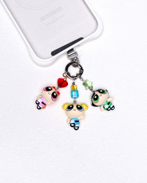 Product photo of a vintage trio character phone charm with colorful Swarovski crystal accents.