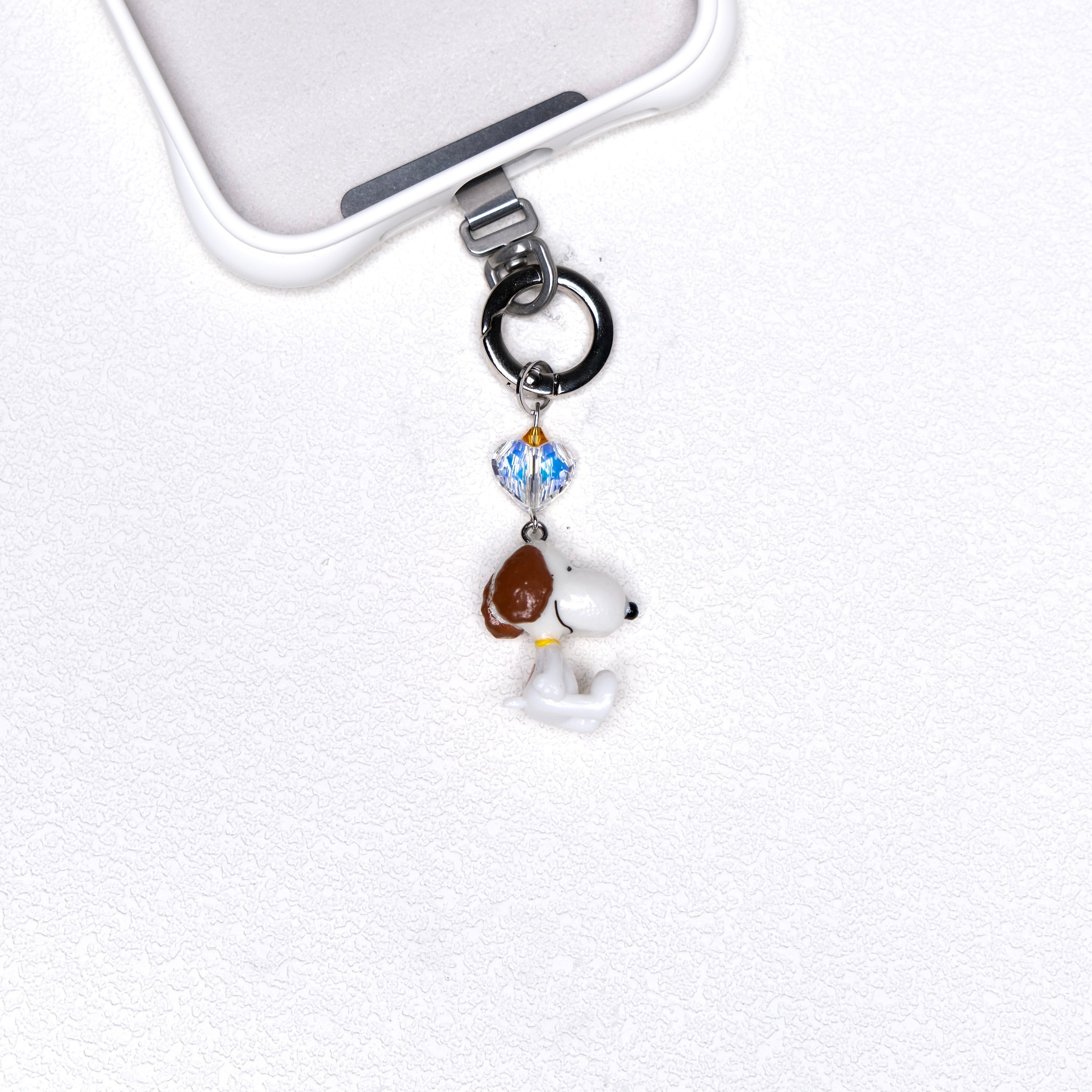 Product photo of a vintage dog phone charm with a Swarovski crystal heart accent.