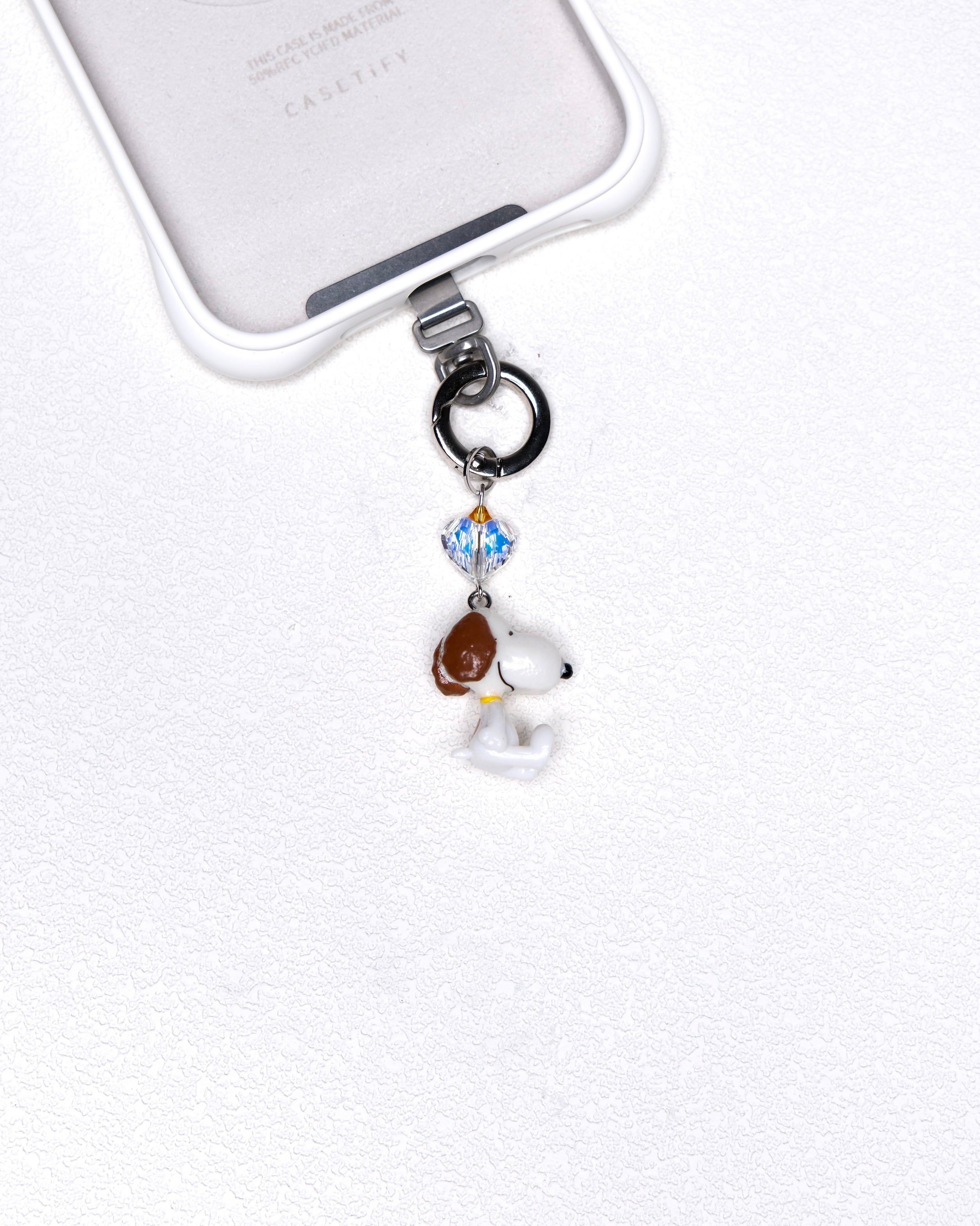 Product photo of a vintage dog phone charm with a Swarovski crystal heart accent.