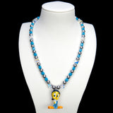 Additional product photo of a blue crystal and charcoal pearl charm necklace with a vintage yellow character charm.