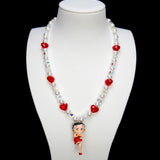 Product photo of a red heart vintage charm necklace with Swarovski crystals and pearls.