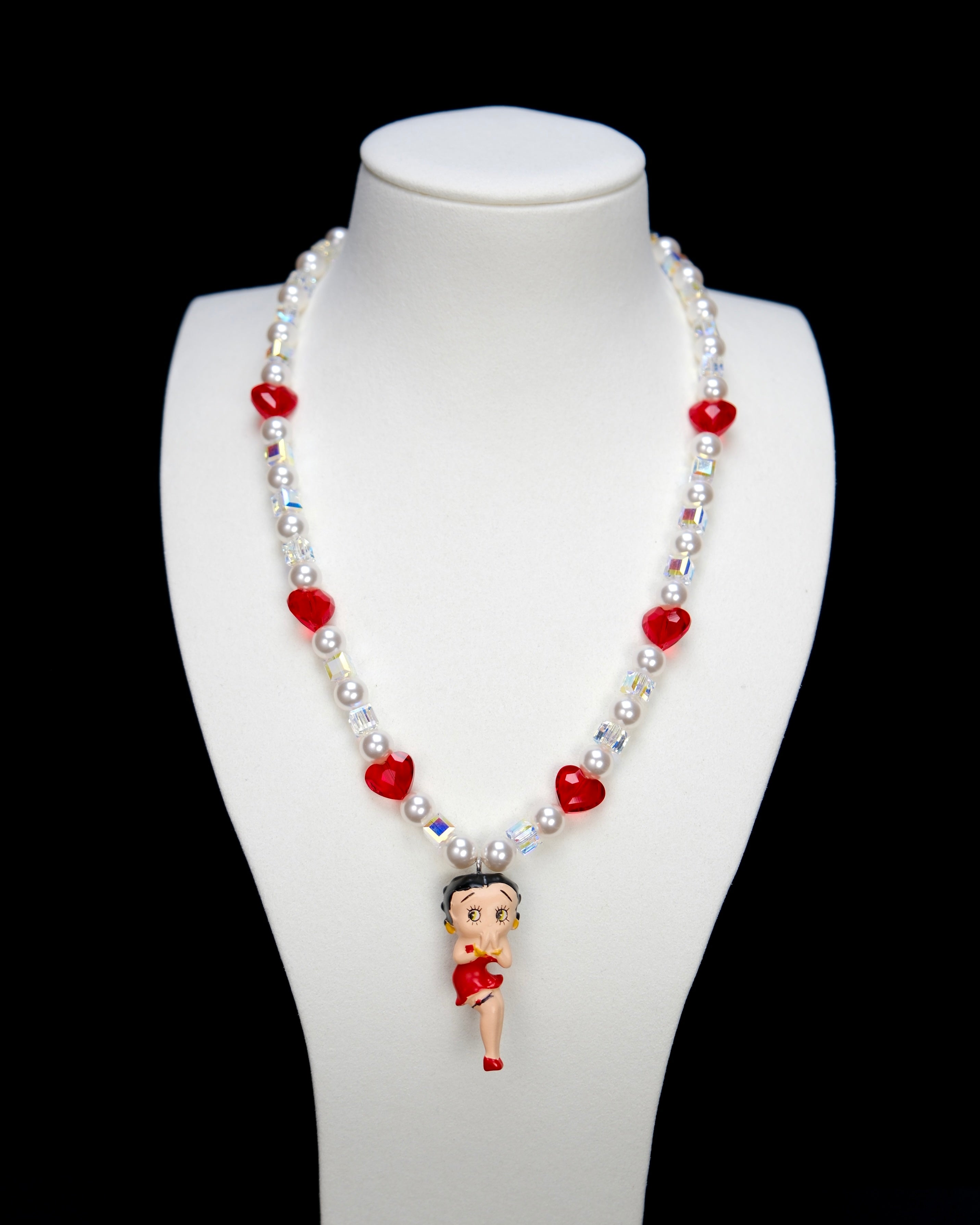 Product photo of a red heart vintage charm necklace with Swarovski crystals and pearls.
