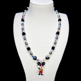 Detail product photo of a black and silver mouse charm necklace with gray pearls and black crystal beads.