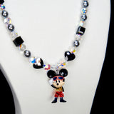 Alternate product photo of a black and silver mouse charm necklace with gray pearls and black crystal beads.