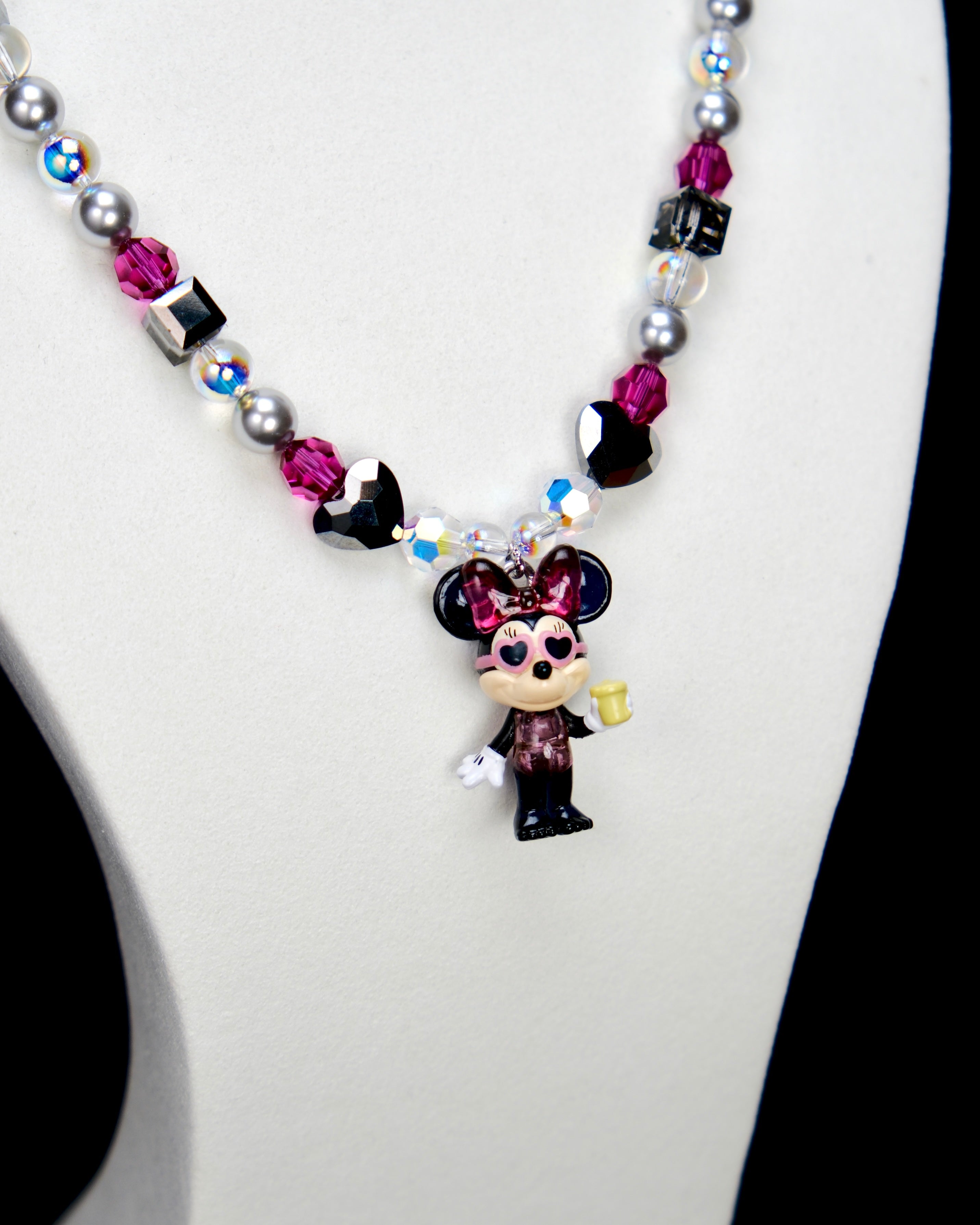Alternate product photo of a pink and silver mouse charm necklace with gray pearls and pink crystal beads.