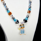 Alternate product photo of an orange and blue duck charm necklace with gray pearls and faceted crystal beads.