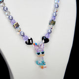 Alternate product photo of a lavender and blue duck charm necklace with pearl and iridescent crystal beads.