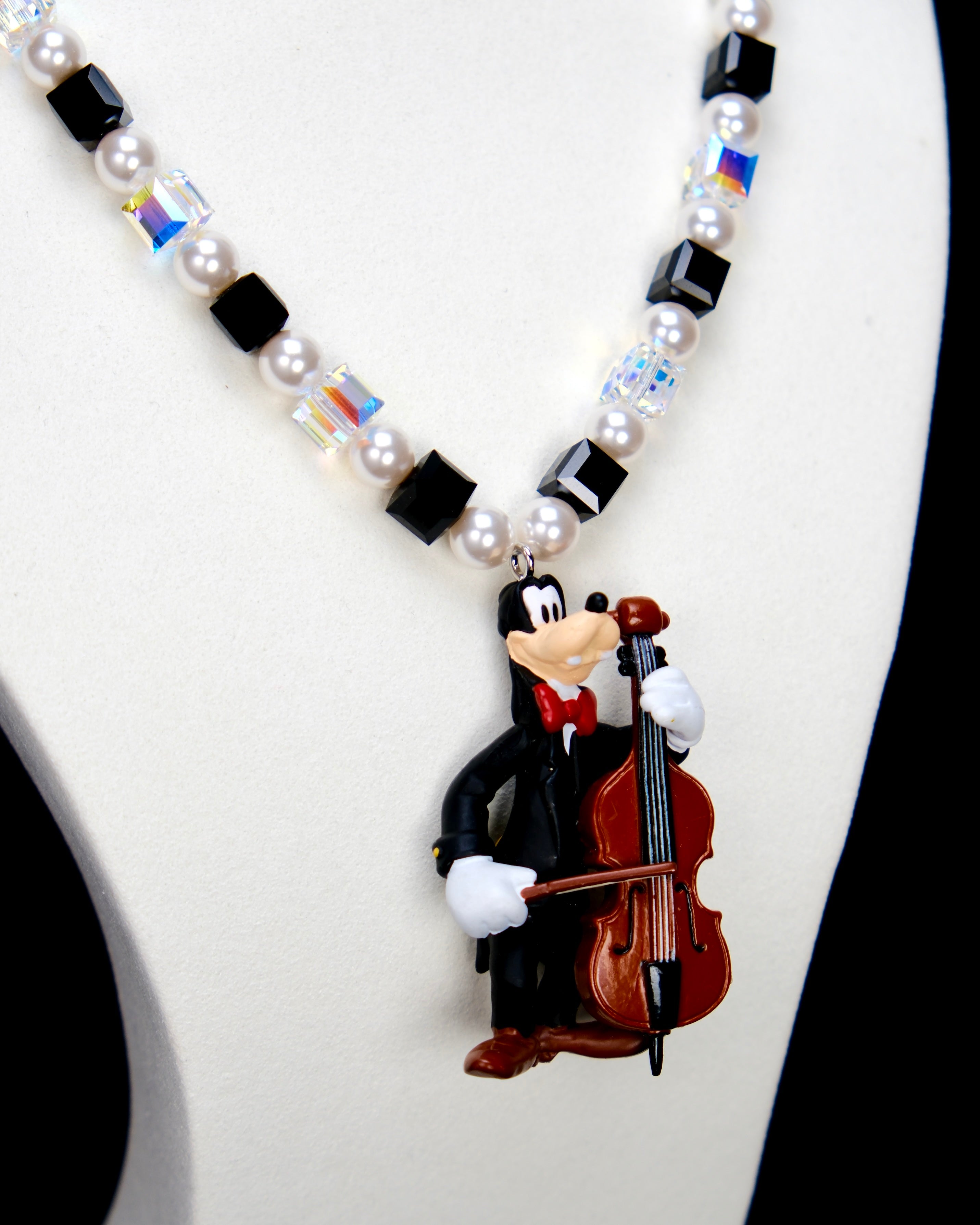 Additional product photo of a cello-player vintage charm necklace with Swarovski crystals and pearls.