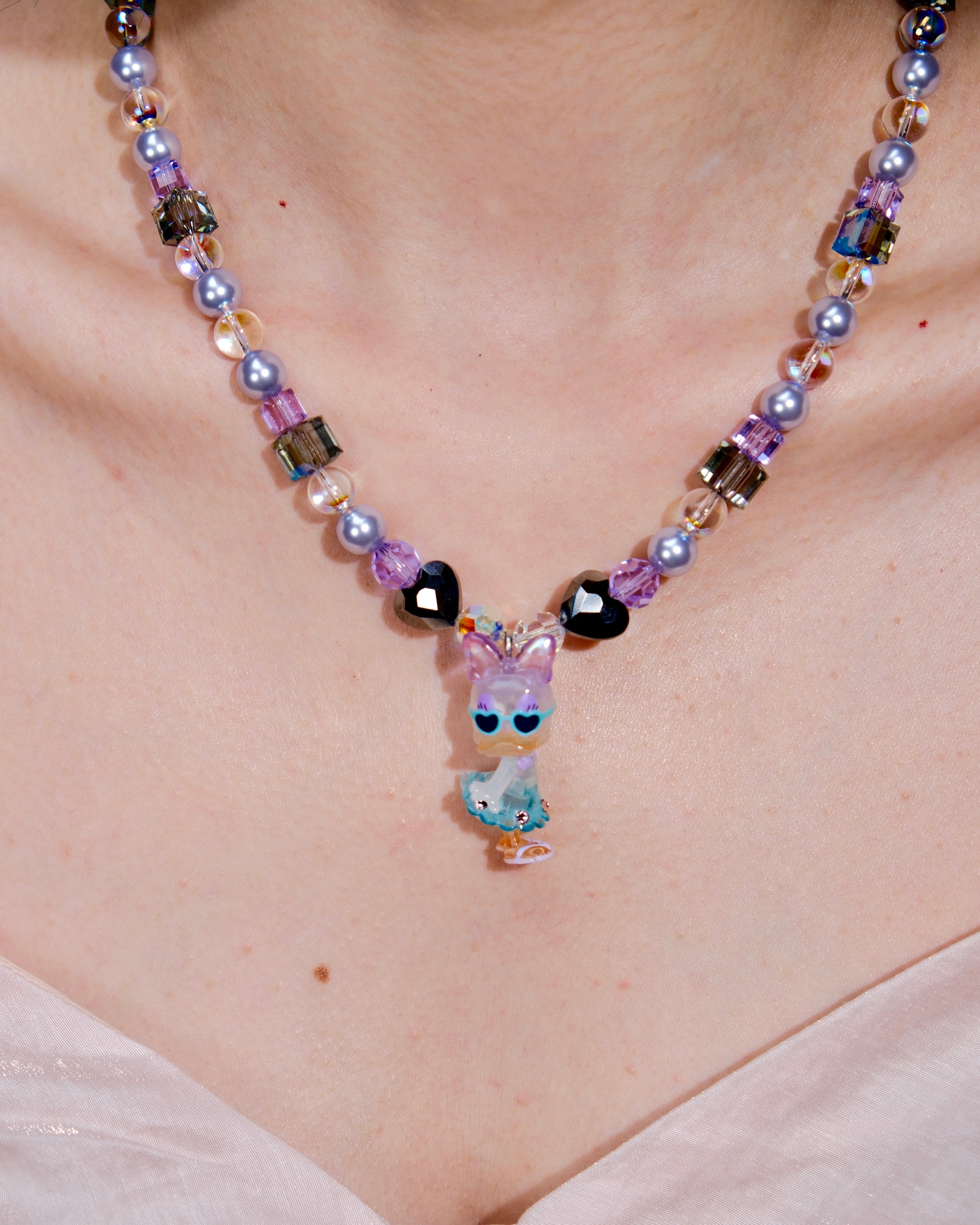 Additional product photo of a lavender and blue duck charm necklace with pearl and iridescent crystal beads.