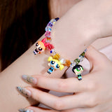 Additional product photo of a rainbow crystal charm bracelet with three vintage heroine character charms.