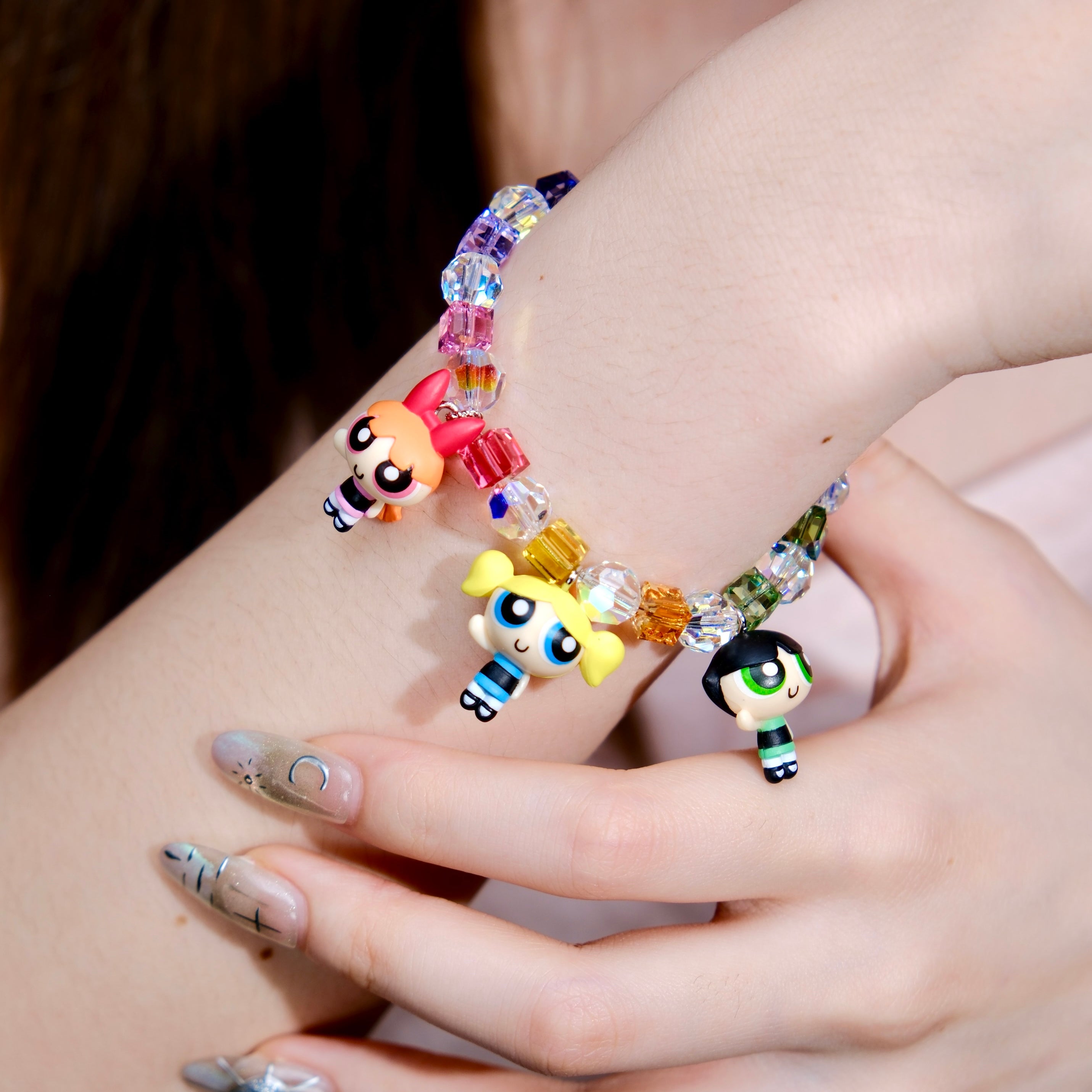 Additional product photo of a rainbow crystal charm bracelet with three vintage heroine character charms.