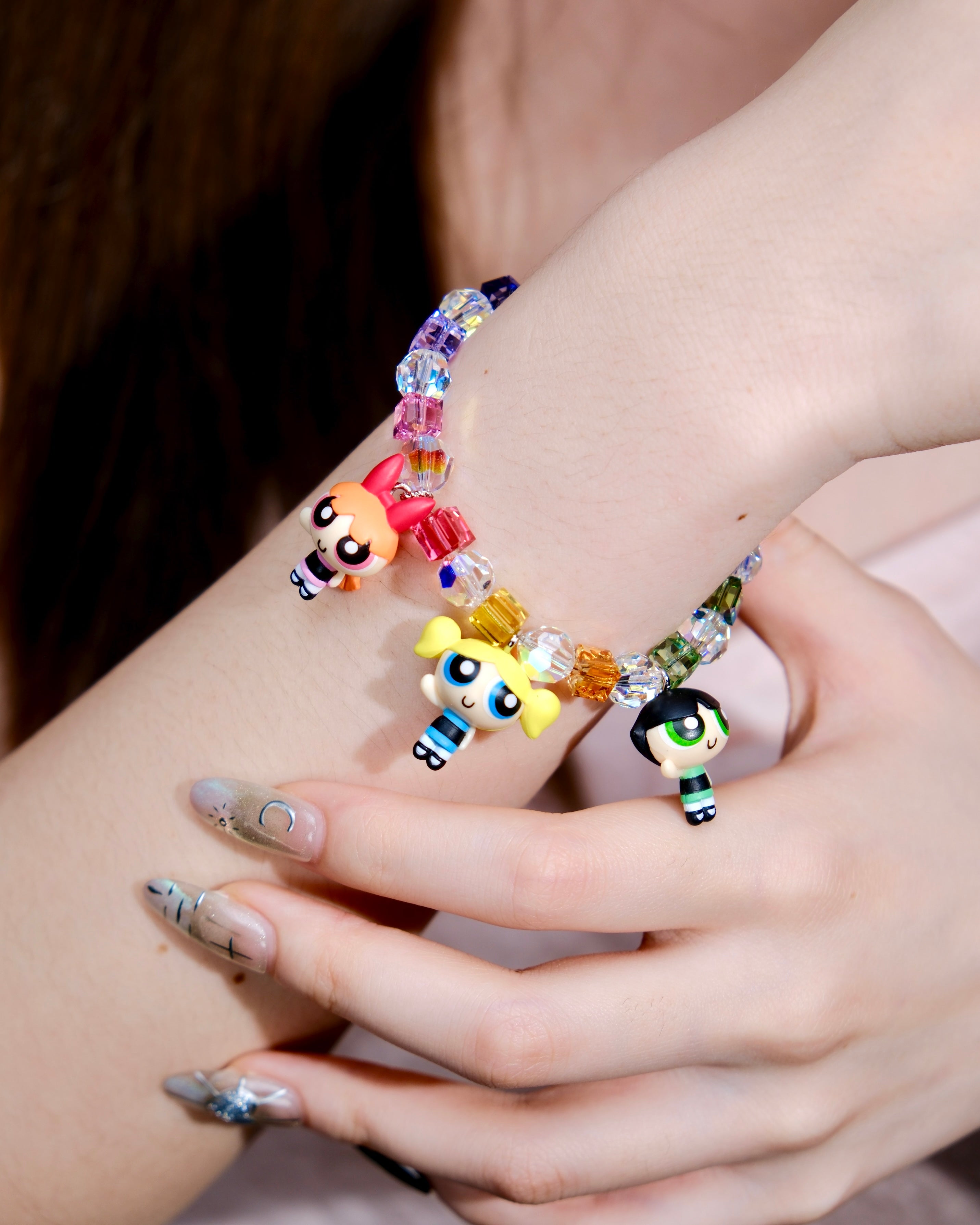 Additional product photo of a rainbow crystal charm bracelet with three vintage heroine character charms.