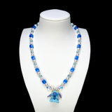 Product photo of Blue Creature Necklace by Shinora Studio.