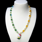 Front studio product view of Green Fairway Crystal Charm Necklace on a white jewelry display against a black background.