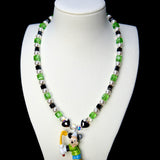 Front studio product view of Emerald Quest Crystal Charm Necklace on a white jewelry display against a black background.