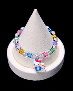 Front studio product view of Rainbow Friends Crystal Charm Bracelet on a white jewelry display against a black background.
