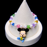 Front studio product view of Rainbow Keepsake Crystal Charm Bracelet on a white jewelry display against a black background.