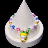 Front studio product view of Lemon Glow Crystal Charm Bracelet on a white jewelry display against a black background.