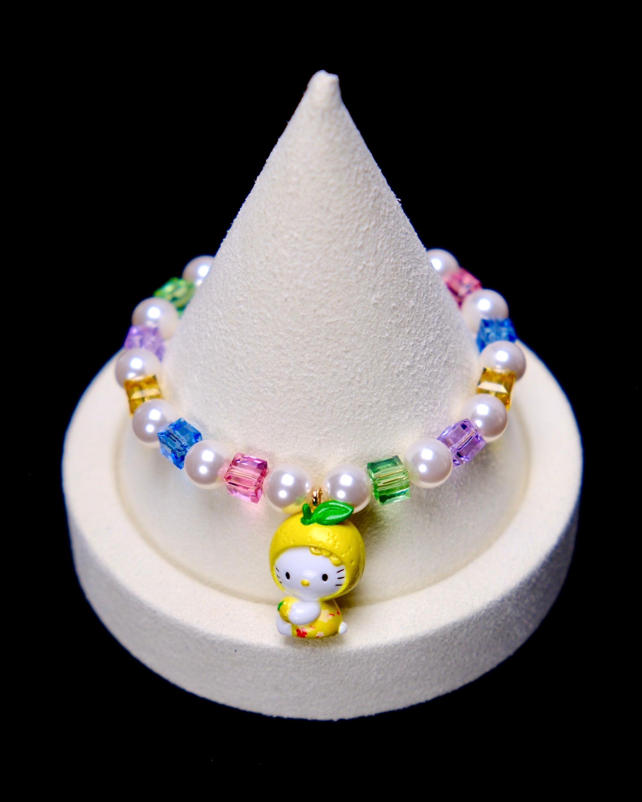 Front studio product view of Lemon Glow Crystal Charm Bracelet on a white jewelry display against a black background.
