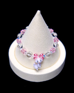 Front studio product view of Pink Bow Crystal Charm Bracelet on a white jewelry display against a black background.