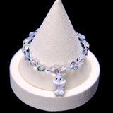 Front studio product view of Iridescent Bunny Crystal Charm Bracelet on a white jewelry display against a black background.