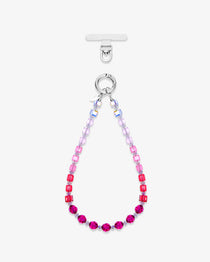 Pink ombre crystal phone strap fading from clear and blush beads to deep berry crystals, shown in a loop on white.