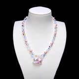 Sweethearts Cat Duo Necklace with pink pearls, iridescent crystals and a pink heart cat-pair pendant on a white bust.