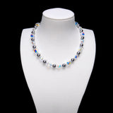 Midnight Prism Pearl Choker with dark gray pearls alternating with iridescent crystal cubes on a white bust.