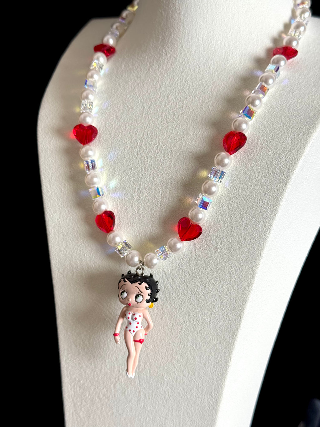 Close-up of vintage Betty Boop collectible charm on handmade Swarovski crystal and pearl necklace
