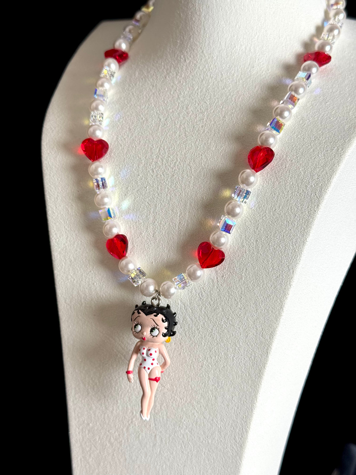 Close-up of vintage Betty Boop collectible charm on handmade Swarovski crystal and pearl necklace