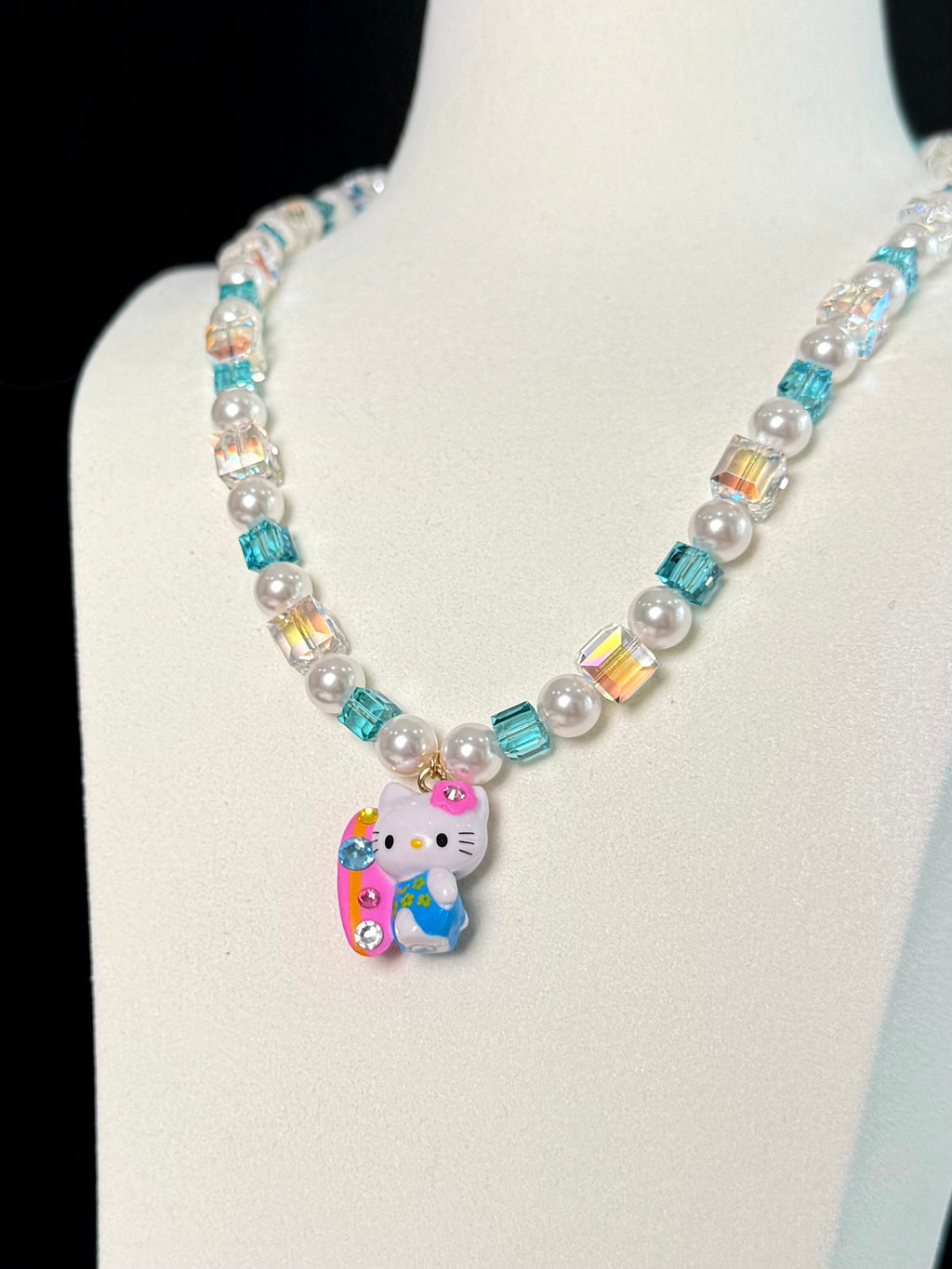 Model wearing handmade aqua blue crystal charm necklace with Swarovski beads and pearls