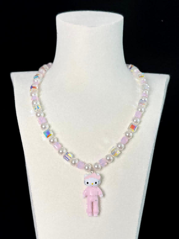 Iridescent Swarovski crystal beads close-up on handmade pearl charm necklace by ShinoraStudio
